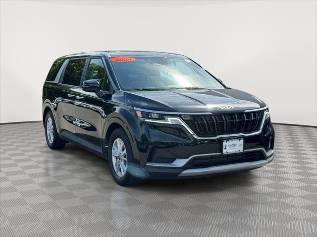 2024 Kia Carnival LX in Aurora Black Pearl — front three-quarter view
